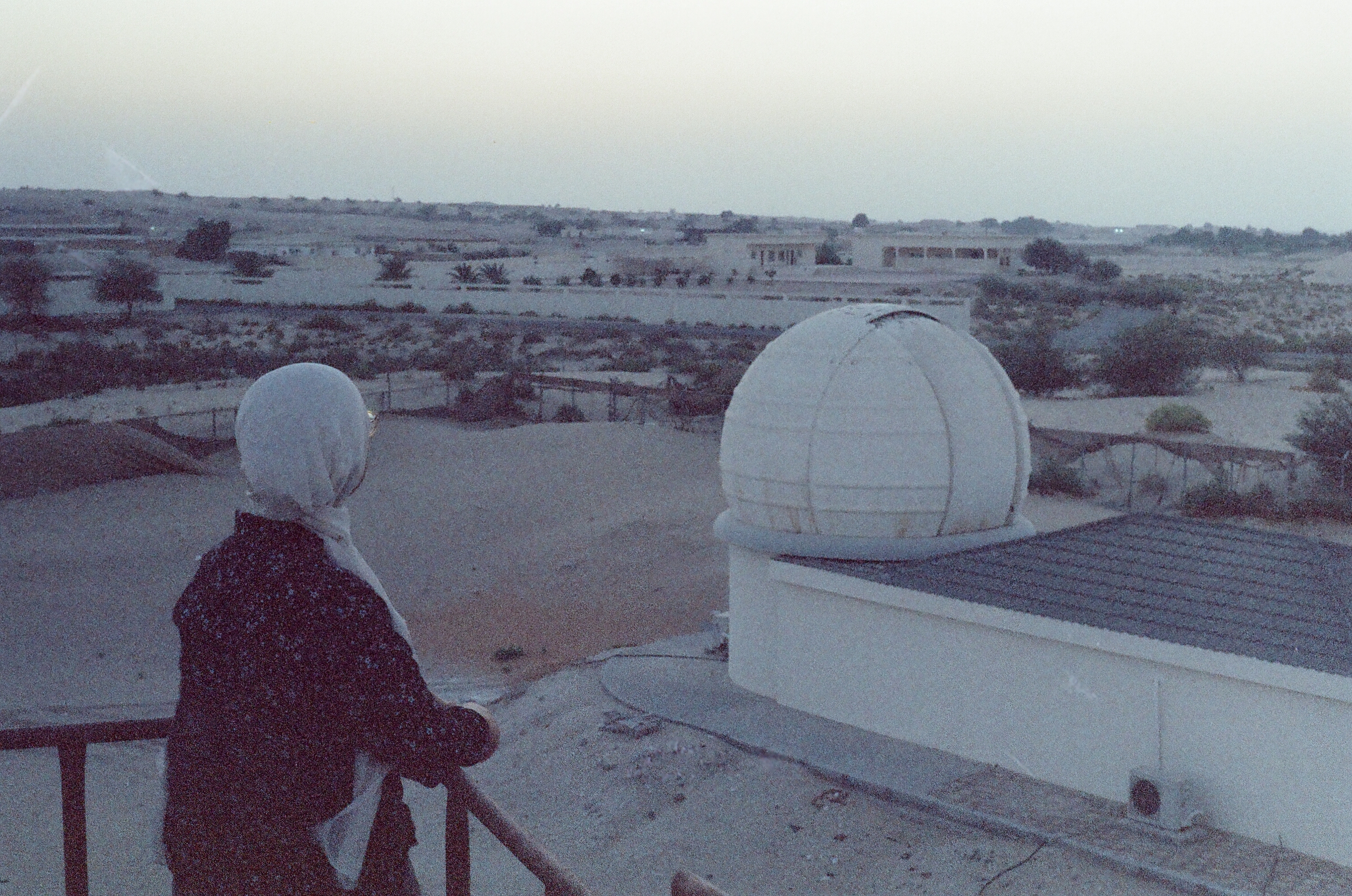 Jasmine in front of the dome of Al Sadeem Observatory in the desert of Al Wathaba, Abu Dhabi, UAE